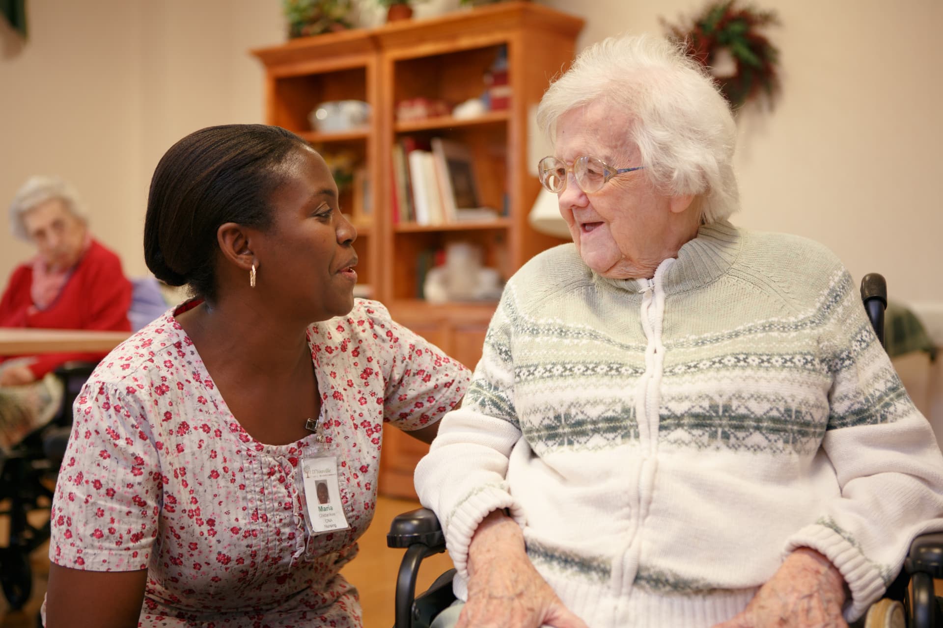 A caregiver sharing a warm moment with a resident